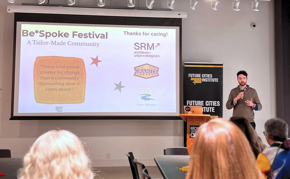 Skyler presenting the Be*Spoke Festival on stage at the Elora Centre for the Arts.