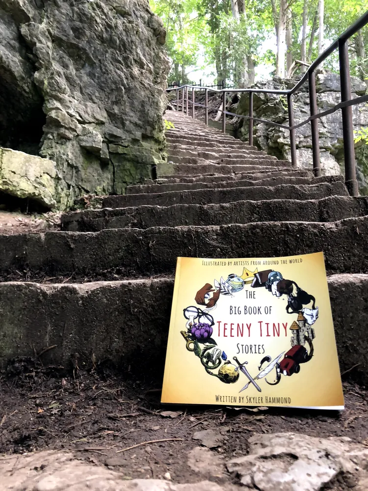The Big Book of Teeny Tiny Stories propped on stone steps in the Elora Gorge.